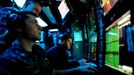 April 25, 2011 - Fort Lauderdale, Florida, U.S. - -- Fort Lauderdale, Fla. -- David Conlan, Sonar Tech Sub Chief E-7, looks over Jake Thurman, left, Sonar Technicians Submarine-3, and Daniel Ritzell, far right, Sonar Technicians Submarine Seaman Apprentice, in the sonar room aboard the USS Annapolis (SSN 760), a S6G nuclear reactor powered fast attack submarine, sailing to Port Everglades in Fort Lauderdale on Monday. The USS Annapolis measures 362 ft. in length and 33 ft. at the beam, a diving depth of over 400 ft., 27+ mph, 12 vertical launch missile tubes, 4 torpedo tubes, and a crew of 130 enlisted submariners. The submarine was commissioned April 11, 1992 with its homeport in Groton, Connecticut. USS Annapolis sailed to the 21st Anniversary of Fleet Week at Port Everglades, Fort Lauderdale. (Credit Image: © Gary Coronado/The Palm Beach Post)