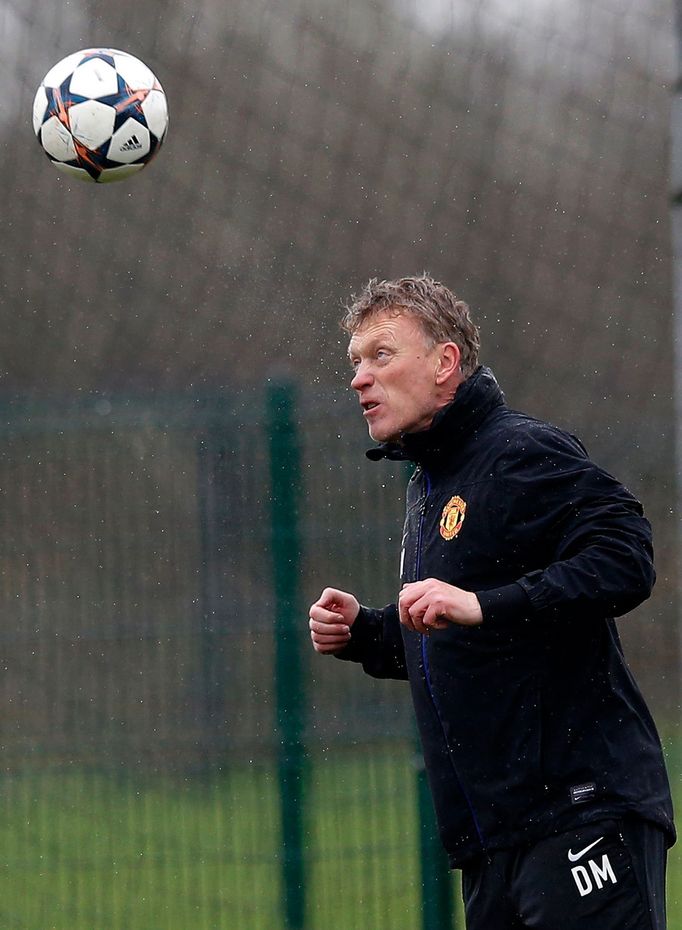 Manchester United's manager Moyes heads a ball during a training session at the clu