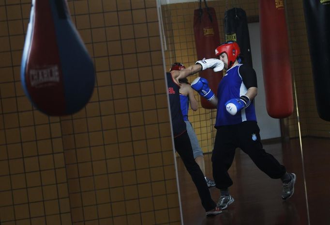 Argentine born boxer Tamara Fabiana Garcia gets punched in the face by fellow boxer Jennifer Miranda during a training session at a high-performance sports centre in Los Alcazares, southeastern Spain, April 2, 2012. Five young fighters are training hard ahead of next month's world championships in Qinhuangdao, China, where competition will be fierce for the precious 24 qualification slots - eight in each of the three weight categories - for this year's summer Games. Women's boxing is being included in the Olympics for the first time in London and while the Spanish hopefuls know it will be incredibly tough to even qualify, they are filled with pride that the sport they have dedicated their lives to is finally getting the recognition they believe it deserves. Picture taken April 2, 2012. TO MATCH FEATURE OLYMPICS-BOXING/WOMEN-SPAIN REUTERS/Susana Vera (SPAIN - Tags: SPORT BOXING OLYMPICS)