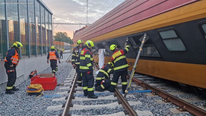 Drážní hasiči pracují na odstranění následků srážky vlaků v Pardubicích.