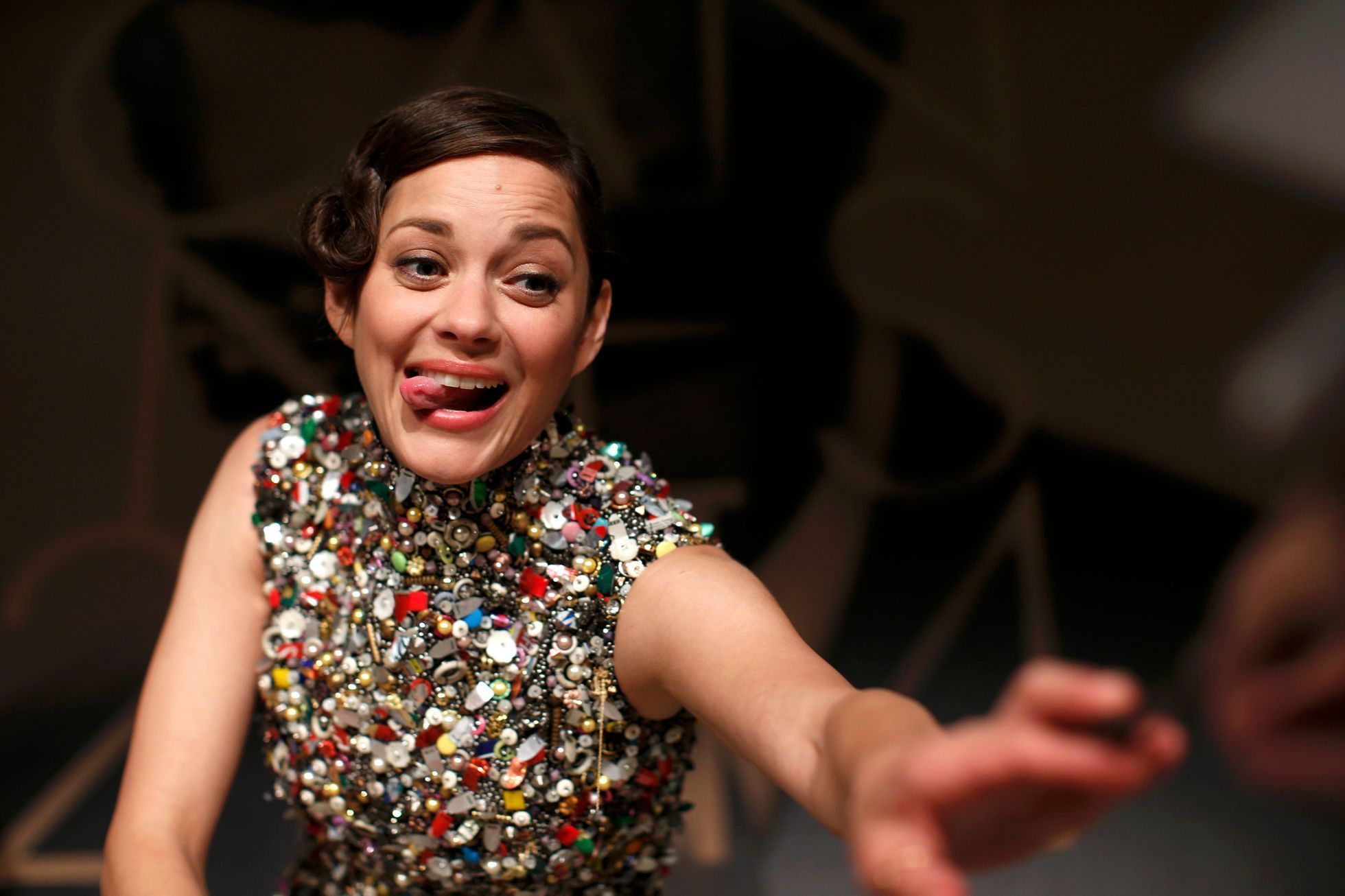 Cast member Marion Cotillard reacts as she signs autographs at the end of a news conference for the film &quot;Deux jours, une nuit&quot; in competition at the 67th Cannes Film Festival in Cannes