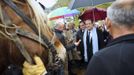 Hollande, Socialist Party candidate for the 2012 French presidential election, speaks to the media as he meets social rehabilitation workers who work in a vineyard during a campaign visit near Besancon