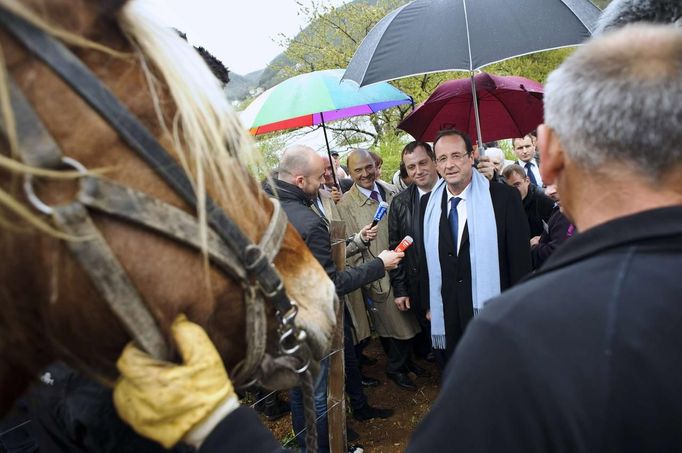 Hollande, Socialist Party candidate for the 2012 French presidential election, speaks to the media as he meets social rehabilitation workers who work in a vineyard during a campaign visit near Besancon