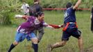 A zombie chases a runner (R) on the "Run for Your Lives" 5K obstacle course race in Amesbury, Massachusetts May 5, 2012. Runners face man-made and natural obstacles on the course, while being chased by zombies, who try to take "health" flags off the runners belts. REUTERS/Brian Snyder (UNITED STATES - Tags: SPORT SOCIETY) Published: Kvě. 5, 2012, 8:09 odp.