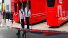 Police officers are reflected in a window as they patrol the paddock before the final practice session for the British Formula One Grand Prix at the Silverstone Race circ