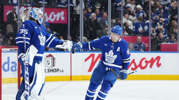 John Tavares slaví gól Toronta s brankářem Dennisem Hildebym.