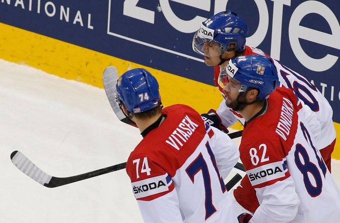 Tomas Rolinek of the Czech Republic (top) celebrates with his team mates Ondrej Vitasek (L) and Michal Vondrka after scoring against the U.S. during their men's ice hocke