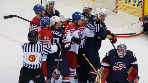 U.S. and Czech Republic players are stopped from fighting by referees during their men's ice hockey World Championship quarter-final game at Chizhovka Arena in Minsk May