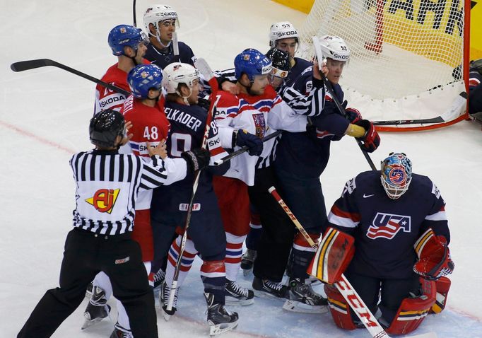 U.S. and Czech Republic players are stopped from fighting by referees during their men's ice hockey World Championship quarter-final game at Chizhovka Arena in Minsk May