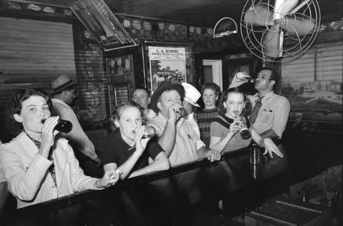 2_ Men and women drinking beer at a bar inRaceland, Louisiana, September 1938. Pre-Prohibition saloons were mostly male establishments; post-Prohibition bars catered to both males and females. Drinking at beer the bar, Raceland, Louisiana. September 1938. Author Russell Lee