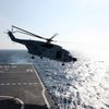 A helicopter takes off from Jinggangshan warship to search the waters suspected to be the site of the missing Beijing-bound Malaysia Airlines flight MH370