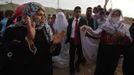 Palestinian groom Emad al-Malalha, 21, walks with Manal Abu Shanar, 17, his Egyptian bride as they arrive from a smuggling tunnel in Rafah in the southern Gaza Strip March 21, 2013. Al-Malaha , who said that his bride was not given a permit from Egyptian authorities to enter the Gaza Strip, brought her from neighboring Egypt through a smuggling tunnel to celebrate his wedding in his native Gaza Strip. REUTERS/Ibraheem Abu Mustafa (GAZA - Tags: POLITICS SOCIETY) Published: Bře. 21, 2013, 6:20 odp.