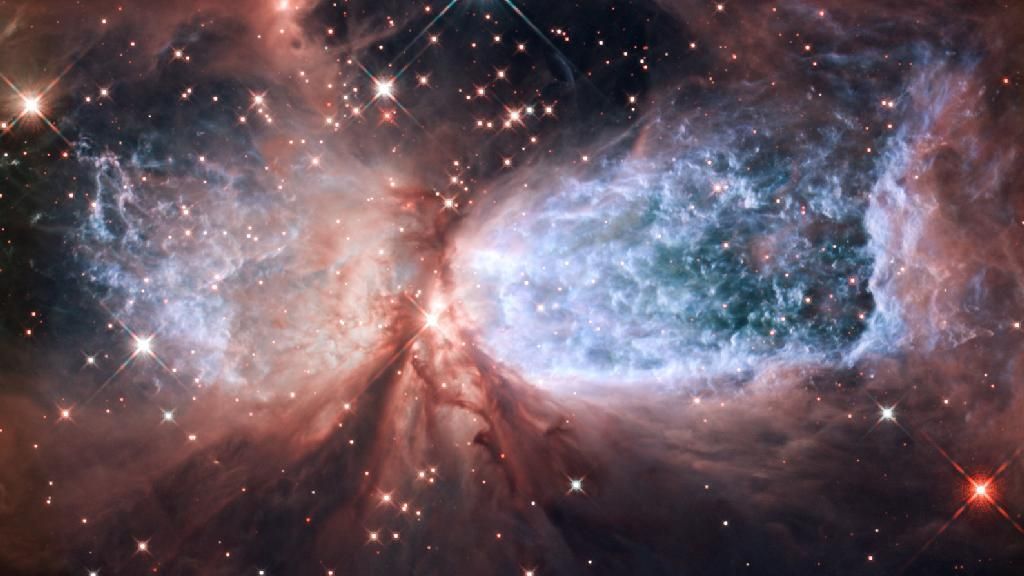 Hubble Serves Up a Holiday Snow Angel The bipolar star-forming region, called Sharpless 2-106, looks like a soaring, celestial snow angel. The outstretched "wings" of the nebula record the contrasting imprint of heat and motion against the backdrop of a colder medium. Twin lobes of super-hot gas, glowing blue in this image, stretch outward from the central star. This hot gas creates the "wings" of our angel. A ring of dust and gas orbiting the star acts like a belt, cinching the expanding nebula into an "hourglass" shape. Image Credit: NASA, ESA, and the Hubble Heritage Team (STScI/AURA)