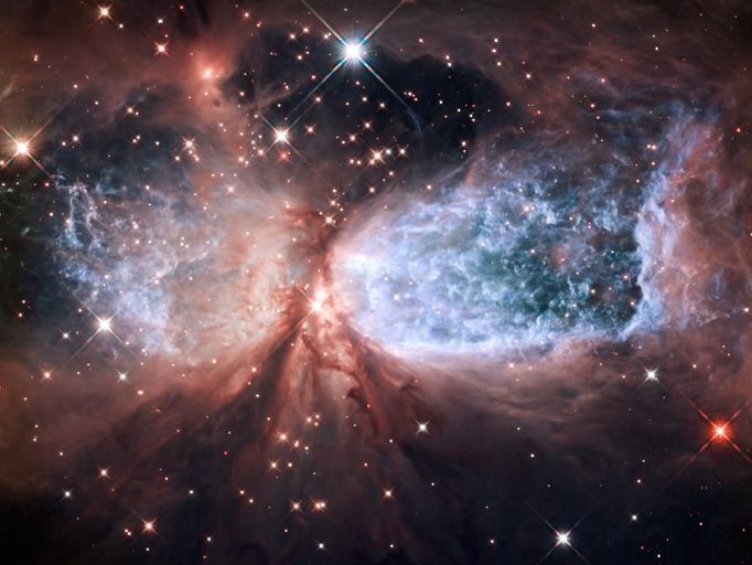 Hubble Serves Up a Holiday Snow Angel The bipolar star-forming region, called Sharpless 2-106, looks like a soaring, celestial snow angel. The outstretched "wings" of the nebula record the contrasting imprint of heat and motion against the backdrop of a colder medium. Twin lobes of super-hot gas, glowing blue in this image, stretch outward from the central star. This hot gas creates the "wings" of our angel. A ring of dust and gas orbiting the star acts like a belt, cinching the expanding nebula into an "hourglass" shape. Image Credit: NASA, ESA, and the Hubble Heritage Team (STScI/AURA)