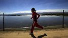 Gladys Tejeda, the first Peruvian athlete who qualified for the 2012 London Olympic Games, runs next to the Chinchaycocha lake during her training in the Andean province of Junin May 14, 2012. A private company will take Gladys' mother Marcelina Pucuhuaranga, 69, to London as part of the "Thank you Mom" program. For Pucuhuaranga, who received her first passport, it will be the first time travelling out of Peru. The program will take about 120 mothers of different athletes around the world to attend the games. Tejeda, the youngest of nine children, returned to her hometown to visit her mother and to focus on training where she will run more than 20 km every day in the highlands (over 4,105 meters above sea level). Picture taken May 14, 2012. REUTERS/Pilar Olivares(PERU - Tags: SPORT ATHLETICS OLYMPICS) Published: Kvě. 17, 2012, 6:12 odp.