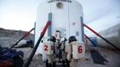 Members of Crew 125 EuroMoonMars B mission return after collecting geologic samples to be studied at the Mars Desert Research Station (MDRS) outside Hanksville in the Utah desert March 2, 2013. The MDRS aims to investigate the possibility of a human exploration of Mars and uses the Utah desert�s Mars-like terrain to simulate working conditions on the red planet. Scientists, students and enthusiasts work together to develop field tactics and study the terrain while wearing simulated spacesuits and carrying air supply packs. They live together in a small communication base with limited space and supplies. Picture taken March 2, 2013. REUTERS/Jim Urquhart (UNITED STATES - Tags: SCIENCE TECHNOLOGY SOCIETY ENVIRONMENT TPX IMAGES OF THE DAY) ATTENTION EDITORS: PICTURE 3 OF 31 FOR PACKAGE 'MARS IN THE DESERT' SEARCH 'JIM MARS' FOR ALL IMAGES Published: Bře. 11, 2013, 2:02 odp.