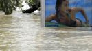 A partially submerged billboard on a tramstop is seen on the flooded embankments of the Danube River in Budapest June 10, 2013. The Hungarian capital escaped damage from the swollen river Danube, which peaked at record high levels in Budapest overnight and started receding slowly on Monday morning. REUTERS/Laszlo Balogh (HUNGARY - Tags: DISASTER ENVIRONMENT TPX IMAGES OF THE DAY)