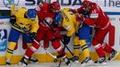 Sweden's Niclas Burstrom (L) and Simon Hjalmarsson (2nd R) balttle for the puck with Belarus'Alexei Kalyuzhny (2nd L) and Andrei Kostitsyn (R) during the second period of