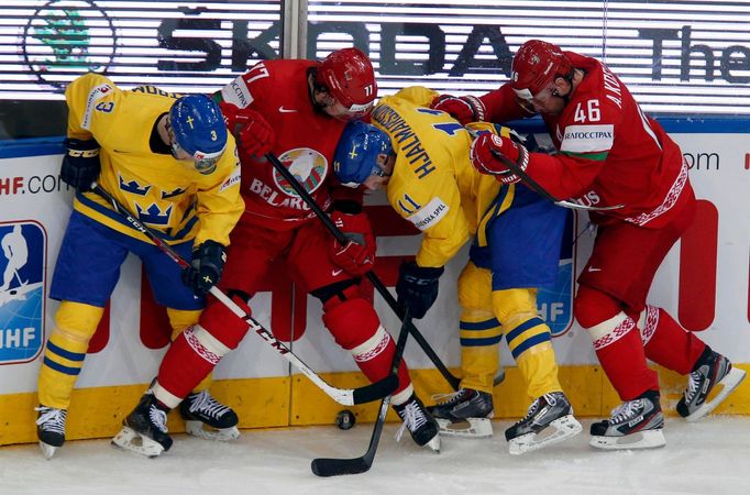 Sweden's Niclas Burstrom (L) and Simon Hjalmarsson (2nd R) balttle for the puck with Belarus'Alexei Kalyuzhny (2nd L) and Andrei Kostitsyn (R) during the second period of