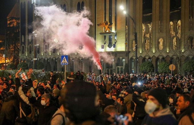 Strážci zákona zadržují muže během shromáždění proti zákonu o "zahraničních agentech" v gruzínském Tbilisi.