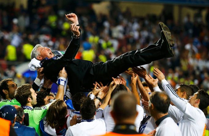 Real Madrid's coach Carlo Ancelotti is thrown in the air by his team after defeating Atletico Madrid in their Champions League final soccer match at Luz stadium in Lisbon