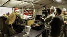 Britain's Prince Harry wears a Santa Claus hat as speaks with media at the VHR (very high readiness) tent at Camp Bastion, southern Afghanistan in this photograph taken December 12, 2012, and released January 21, 2013. The Prince, who is serving as a pilot/gunner with 662 Squadron Army Air Corps, is on a posting to Afghanistan that runs from September 2012 to January 2013. Photograph taken December 12, 2012. REUTERS/John Stillwell/Pool (AFGHANISTAN - Tags: MILITARY POLITICS SOCIETY ROYALS CONFLICT) Published: Led. 21, 2013, 7:43 odp.