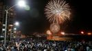 People gather to watch fireworks explode over a beach during New Year celebrations in the coastal city of Vina del Mar, Chile  January 1, 2022. REUTERS/Rodrigo Garrido