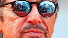 Members of the media are reflected in the sunglasses of cast member Al Pacino as he attends the red carpet for the movie &quot;Manglehorn&quot; at the Venice Film Festival