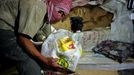 Palestinians carry goods from a tunnel that runs under the border between southern Gaza and Egypt, in the Rafah refugee camp on October 3, 2008. The Egyptian government uncovered and demolished dozens of tunnels running between Egypt and Gaza, reported last week the Israeli newspaper Yediot Aharonot. Palestinians rely on smuggled food and medical supplies through tunnels from Egypt. Israel has closed the crossings with Gaza for legal import goods.