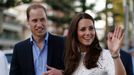 Britain's Prince William and his wife Catherine, the Duchess of Cambridge, smile during their visit to a surf lifesaving demonstration at Sydney's Manly beach