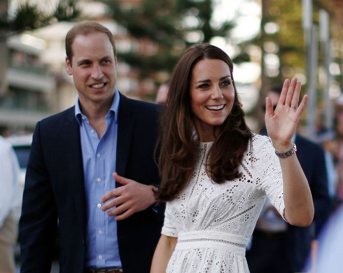 Britain's Prince William and his wife Catherine, the Duchess of Cambridge, smile during their visit to a surf lifesaving demonstration at Sydney's Manly beach