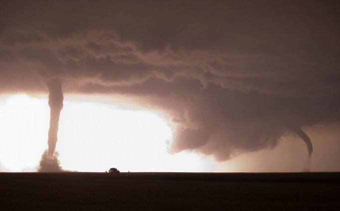 Multiple Tornadoes Illuminated by Lightning A bright burst of lightning illuminates two after-dark tornadoes near La Crosse, Kansas on May 25, 2012