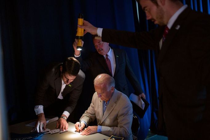 Sept. 2, 2012 "David Lienemann made this unusual photo as staff held flashlights so the Vice President could see as he signed autographs backstage at West York Area High School in York, Pa.