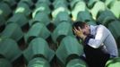 A Bosnian Muslim man sits and cries near the coffin of his relative at Memorial Center in Potocari before a mass burial, near Srebrenica July 11, 2012. The bodies of 520 recently identified victims of the Srebrenica massacre will be buried on July 11, the anniversary of the massacre when Bosnian Serb forces commanded by Ratko Mladic slaughtered 8,000 Muslim men and boys and buried them in mass graves, in Europe's worst massacre since World War Two. REUTERS/Dado Ruvic (BOSNIA - Tags: CONFLICT OBITUARY SOCIETY ANNIVERSARY)