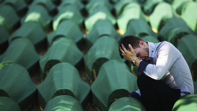 A Bosnian Muslim man sits and cries near the coffin of his relative at Memorial Center in Potocari before a mass burial, near Srebrenica July 11, 2012. The bodies of 520 recently identified victims of the Srebrenica massacre will be buried on July 11, the anniversary of the massacre when Bosnian Serb forces commanded by Ratko Mladic slaughtered 8,000 Muslim men and boys and buried them in mass graves, in Europe's worst massacre since World War Two. REUTERS/Dado Ruvic (BOSNIA - Tags: CONFLICT OBITUARY SOCIETY ANNIVERSARY)