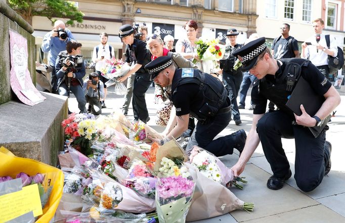 Britští policisté pokládají květiny na místě útoku v Manchesteru.