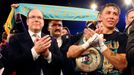 World champion Gennadiy Golovkin of Kazakhstan (R) reacts after defeating Martin Murray of England during the WBA-WBC-IBO Middleweight World Championship, while Prince Al