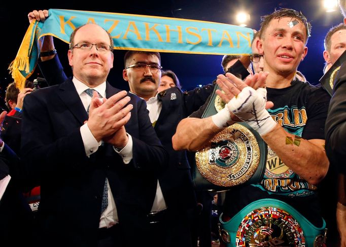 World champion Gennadiy Golovkin of Kazakhstan (R) reacts after defeating Martin Murray of England during the WBA-WBC-IBO Middleweight World Championship, while Prince Al