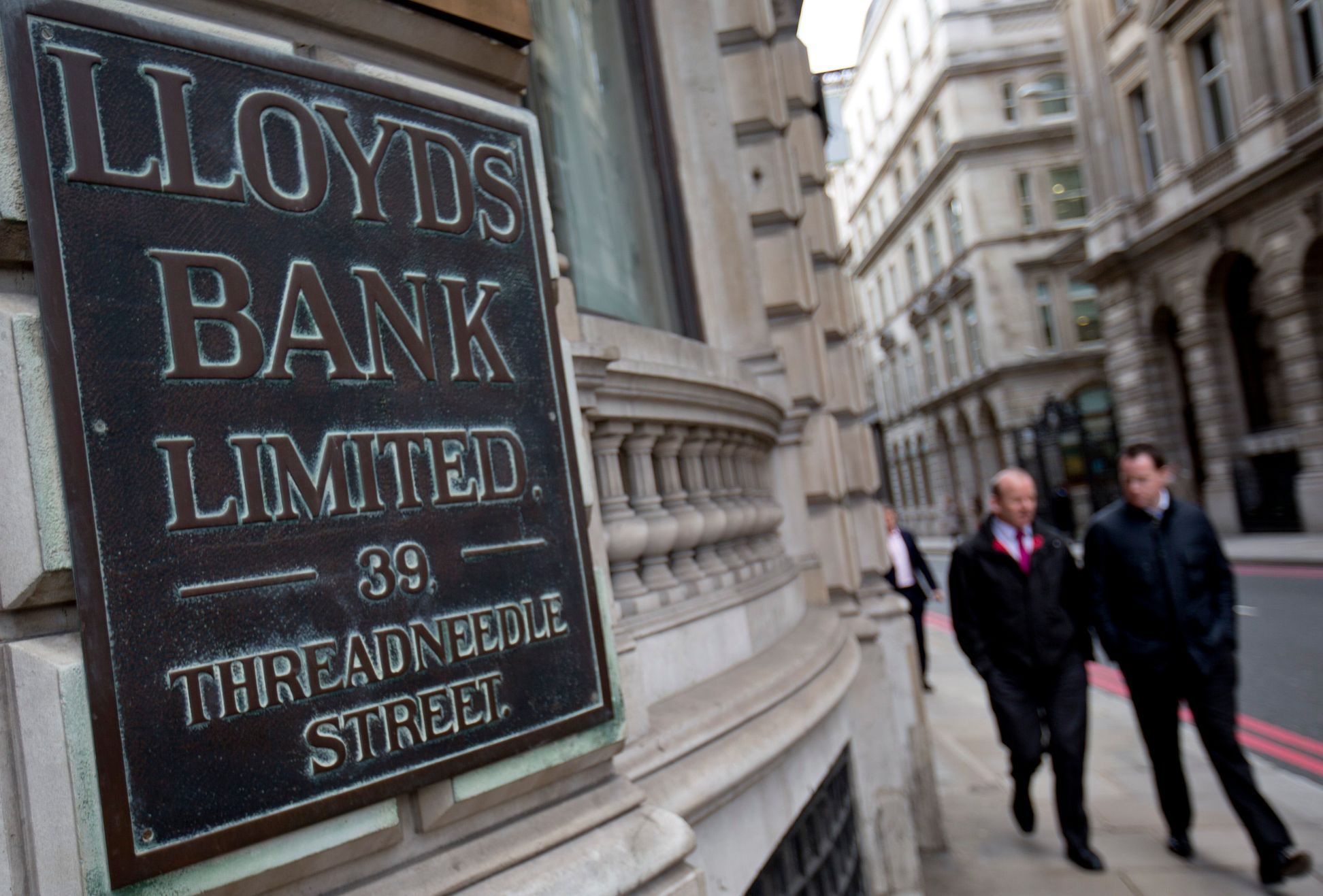 File photograph shows pedestrians walking past a branch of Lloyds Bank in the City London