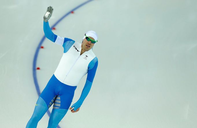 Mika Poutala of Finland waves after becoming an early leader in race two of the men's 500 meters speed skating event during the 2014 Sochi Winter Olympics, February 10, 2