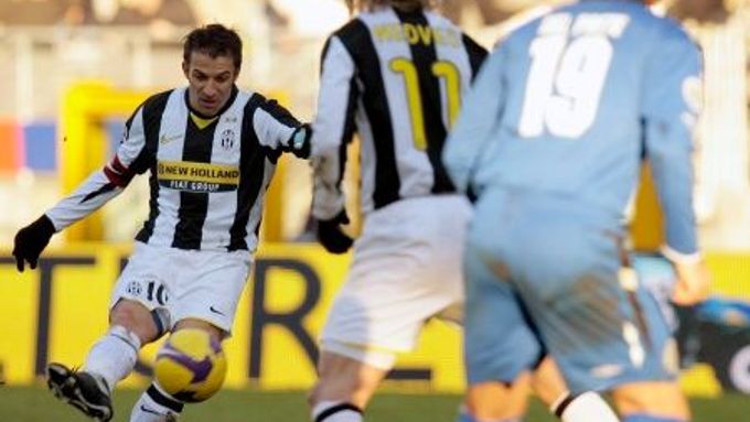 Fotbalista Juventusu Alessandro Del Piero střílí podél Pavla Nedvěda gól do sítě Sieny na Olympijském stadionu v Turíně.