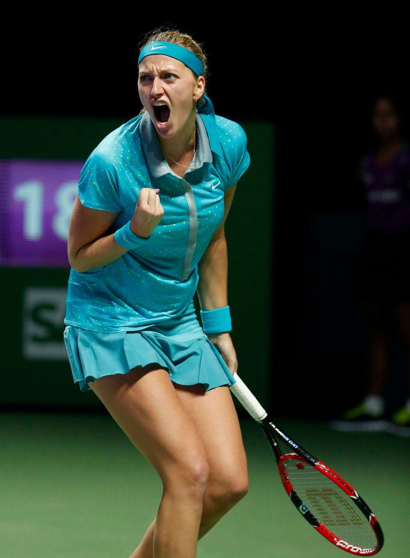 Petra Kvitova of the Czech Republic celebrates a point against Maria Sharapova of Russia during their WTA Finals singles tennis match at the Singapore Indoor Stadium