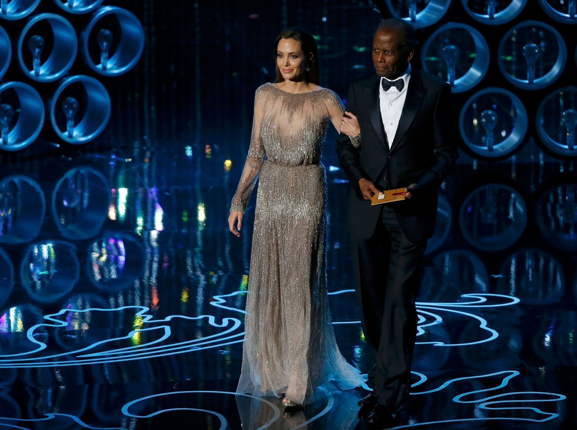 Actors Jolie and Poitier take the stage to present the Oscar for achievement in directing at the 86th Academy Awards in Hollywood