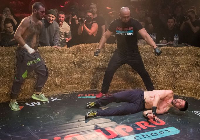 Danik Vesnenok knocks down Danila Utenkov during the "Top Dog" bare-knuckle boxing tournament in Moscow, Russia April 16, 2021. Picture taken April 16, 2021. REUTERS/Sham