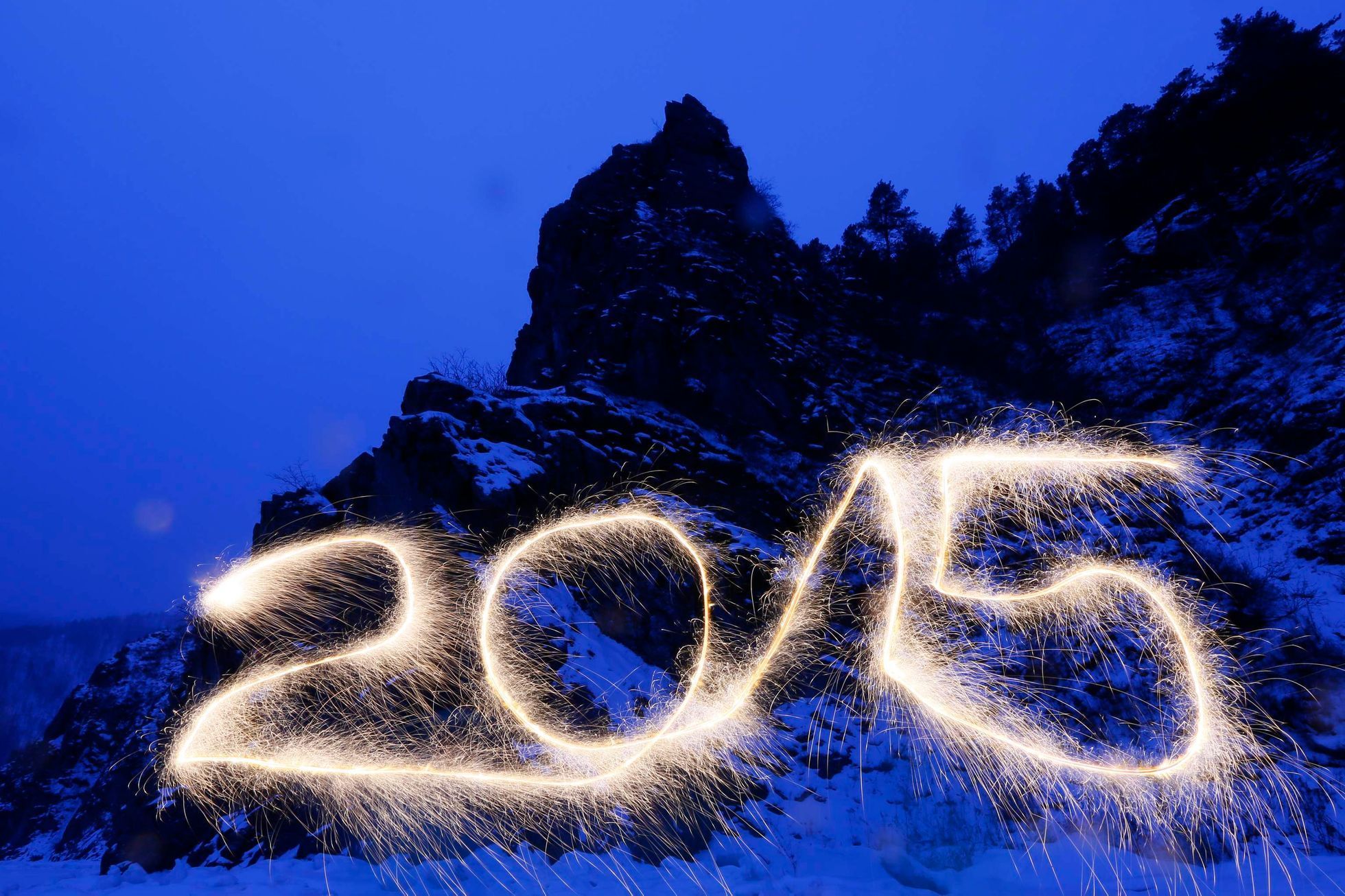 Number &quot;2015&quot; is written in the air with a sparkler at the frozen Mana River in the Taiga district outside Russia's Siberian city of Krasnoyarsk