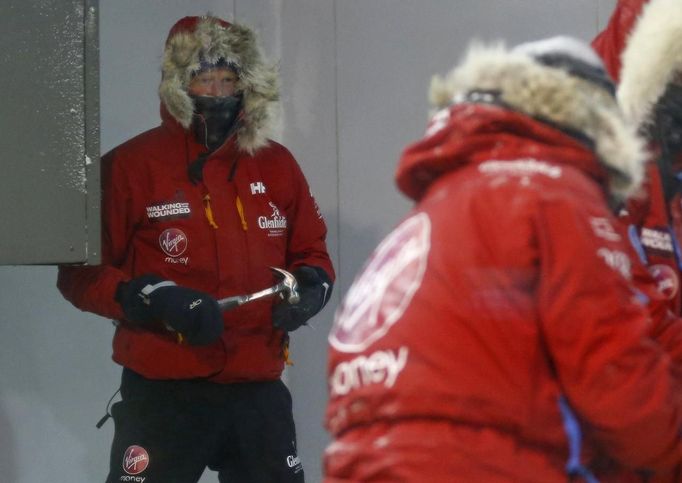 Britain's Prince Harry helps take down a tent during a cold chamber training exercise with the Walking with the Wounded South Pole Allied Challenge 2013 British team at Nuneaton in central England