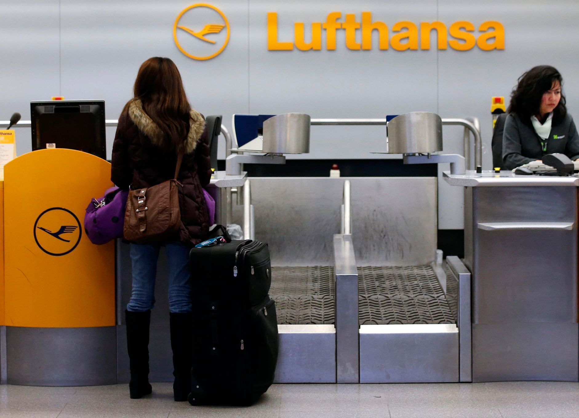 A passenger asks for information at a closed gate of German air carrier Lufthansa at Berlin Tegel airport