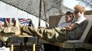 Britain's Prince Harry (R) relaxes with a fellow Apache crew member at Camp Bastion, southern Afghanistan in this photograph taken November 2, 2012, and released January 21, 2013. The Prince, who is serving as a pilot/gunner with 662 Squadron Army Air Corps, is on a posting to Afghanistan that runs from September 2012 to January 2013. Photograph taken November 2, 2012. REUTERS/John Stillwell/Pool (AFGHANISTAN - Tags: MILITARY POLITICS SOCIETY MEDIA ROYALS CONFLICT) Published: Led. 21, 2013, 8:26 odp.