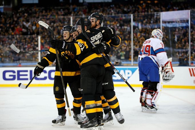 Boston Bruins defenseman Torey Krug (47), center Ryan Spooner (51) and right wing Jimmy Hayes (11) celebrate a third period goal by left wing Matt Beleskey (39)