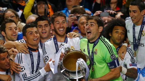 Real Madrid's captain Iker Casillas (3rd R) and team mates celebrate with the trophy after defeating Atletico Madrid in their Champions League final soccer match at the L